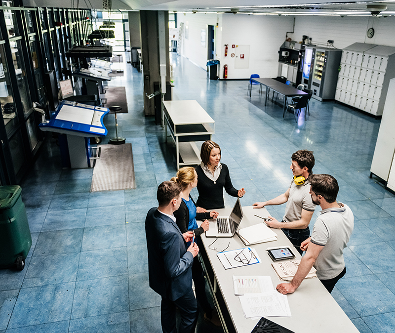 A meeting between a group of engineers at a table