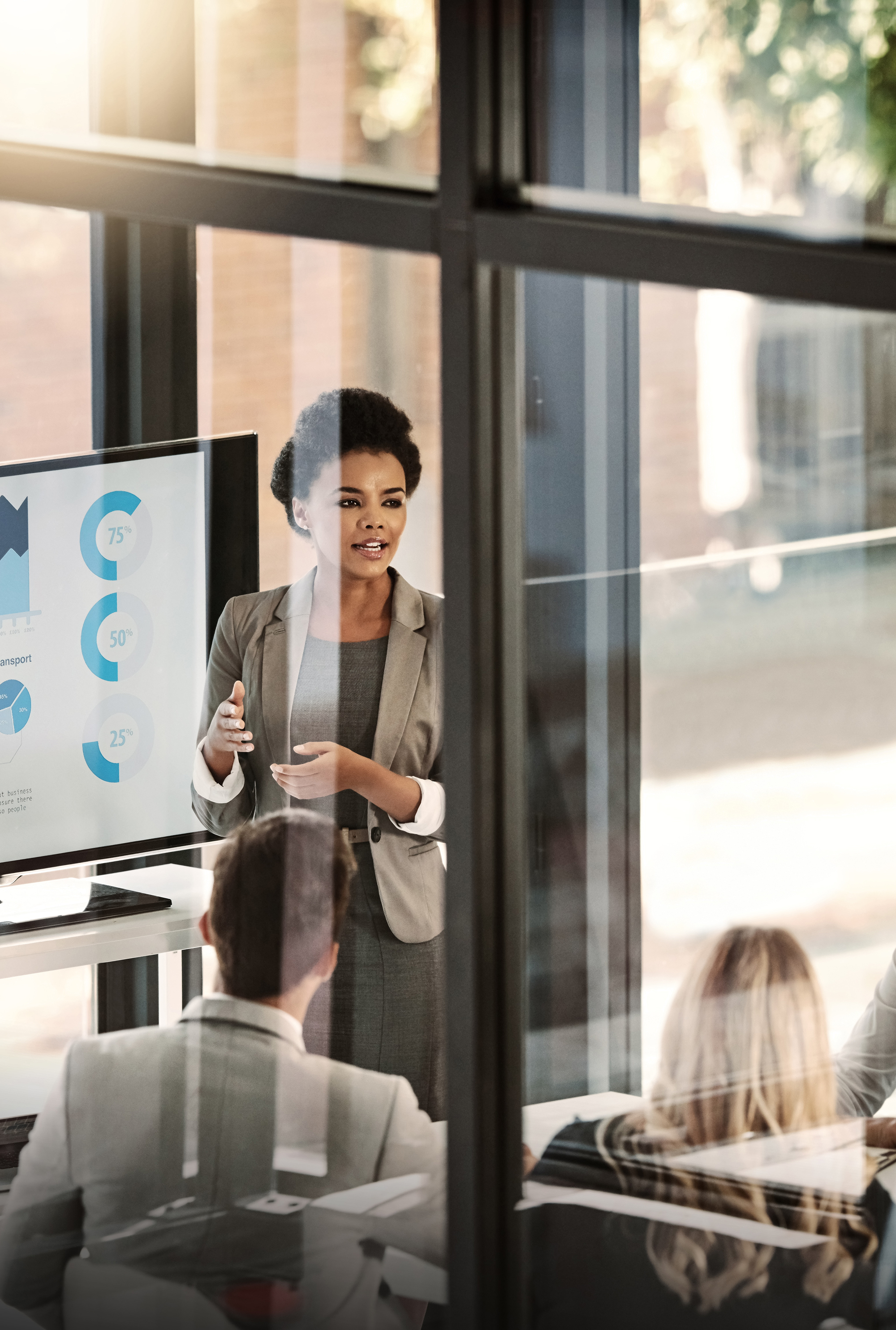 businesswoman delivering a presentation to her colleagues in the boardroom