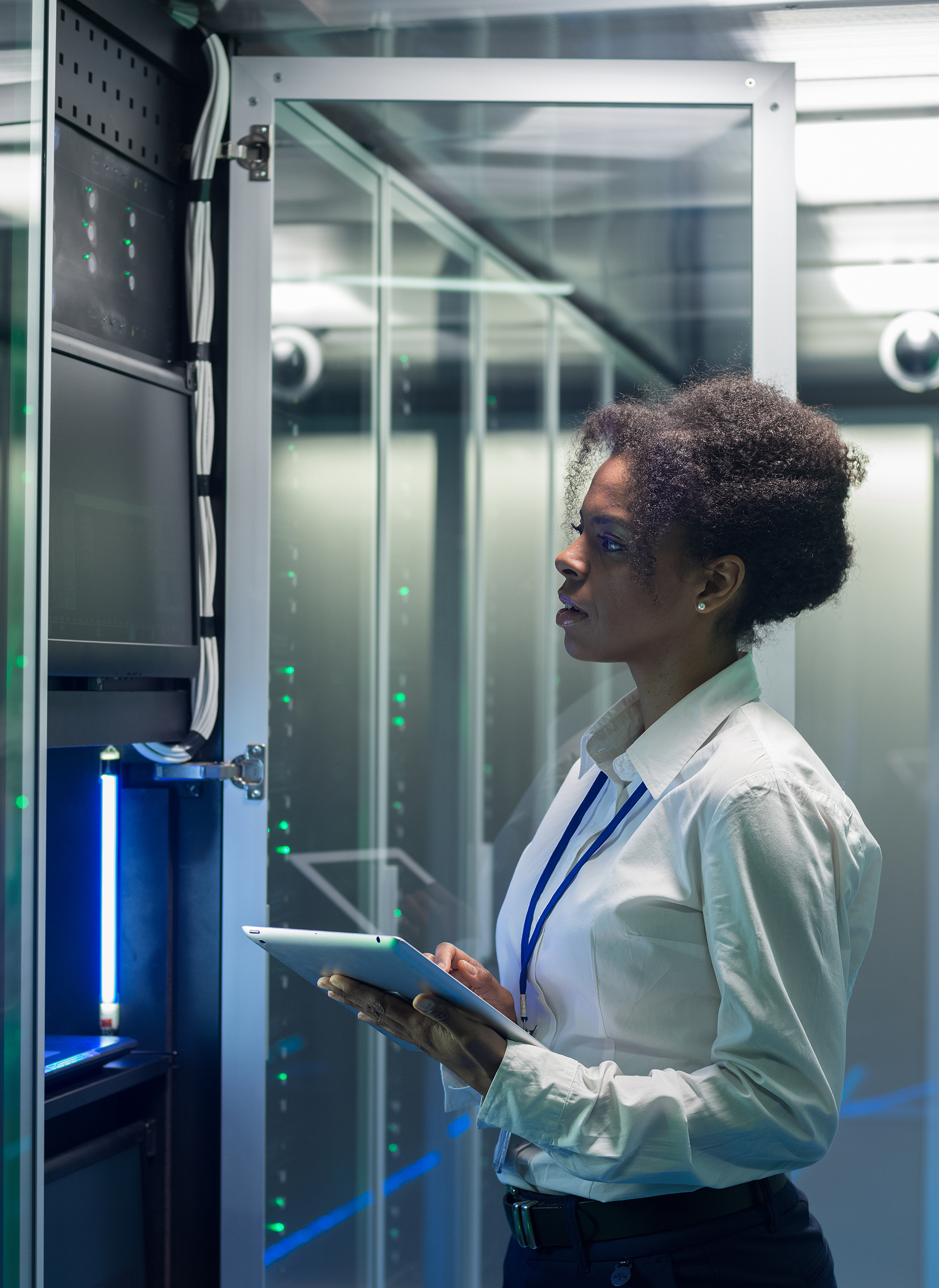 Female technician works on a tablet in a data center
