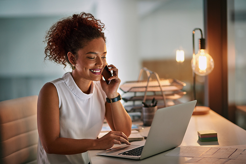 Shot of a cheerful young businesswoman taking a phone call