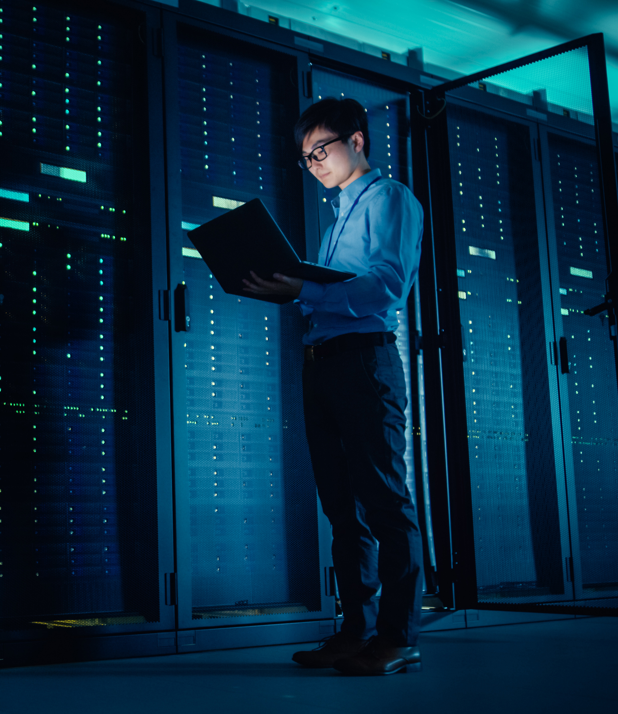 Male IT Technician Running Maintenance Programme on a Laptop
