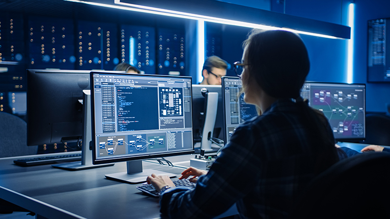 Female IT Programer Working on Desktop Computer in Data Center System Control Room