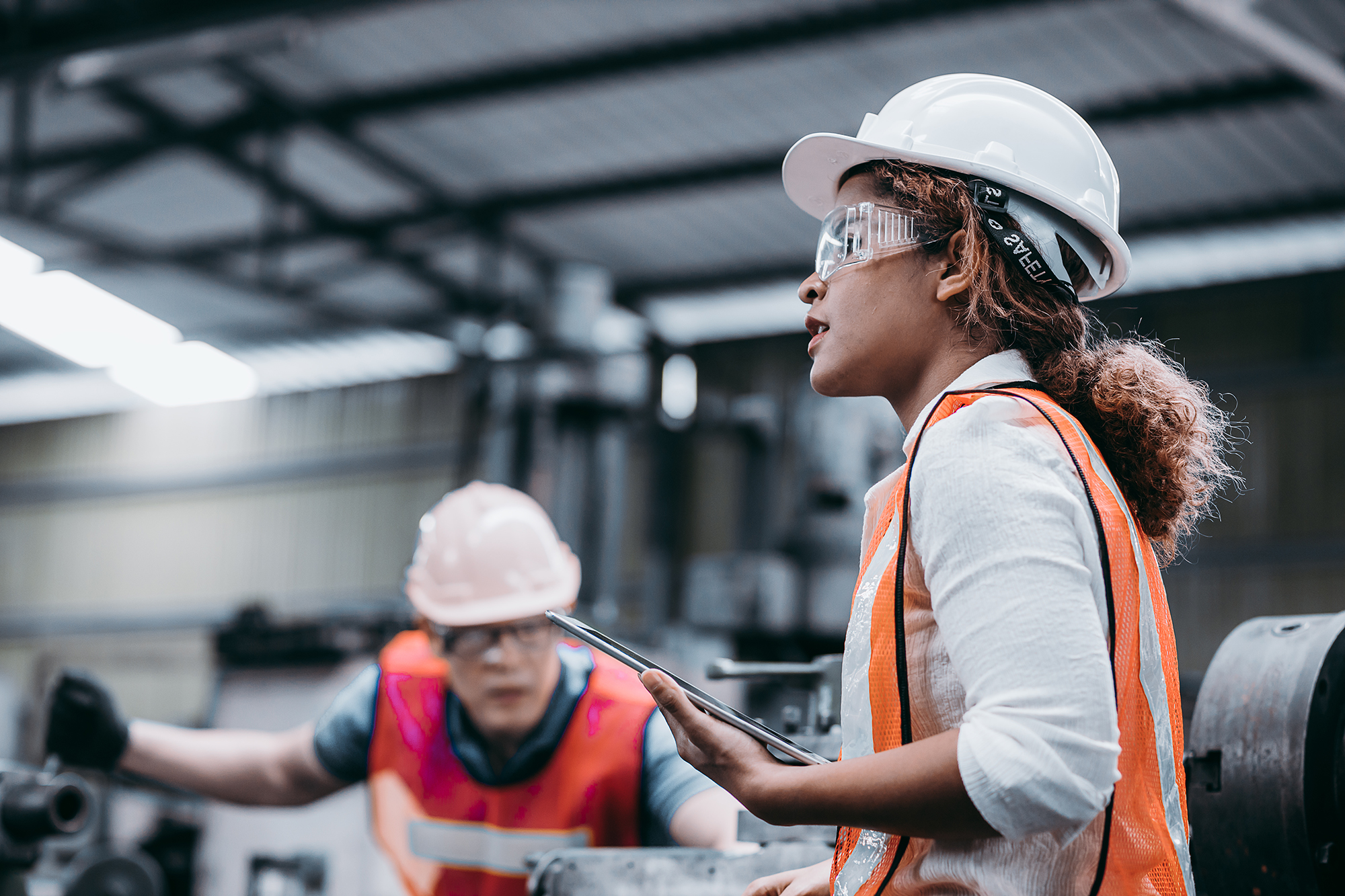Female industrial engineer wearing a white helmet