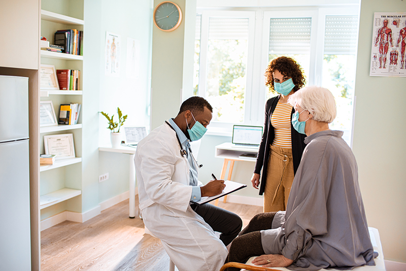 Close up of a senior woman and her daughter having a doctors appointment