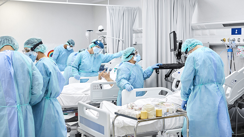 Medical professionals working in a hospital room