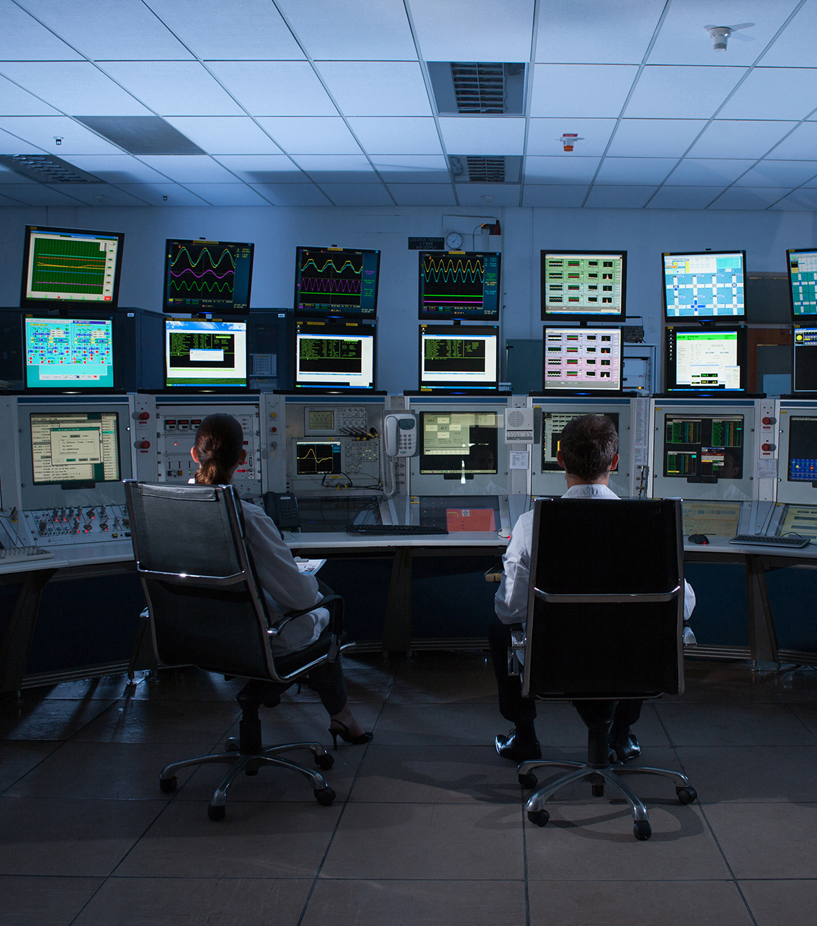 People monitoring computers in control room