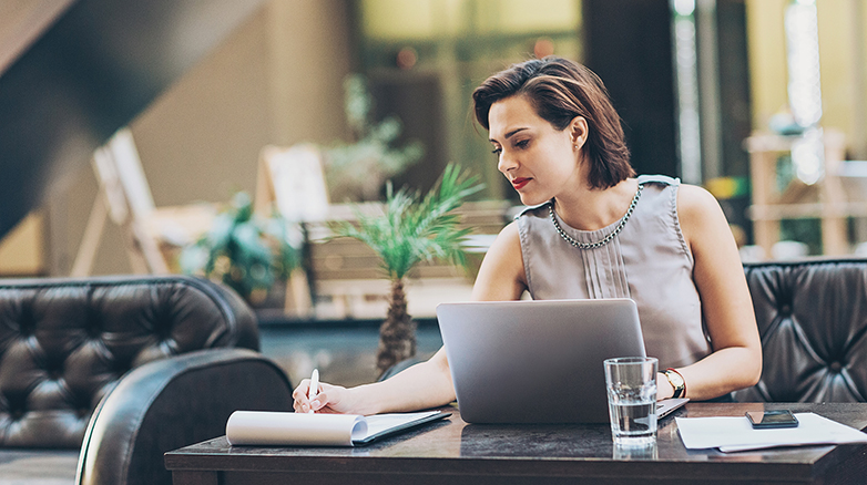 Young businesswoman working in the lobby of a modern business building