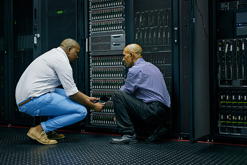 two IT technicians repairing a computer